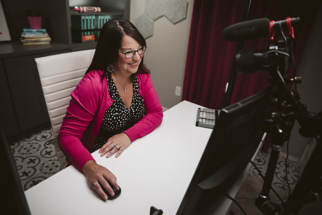 smiling teacher at desk